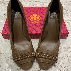 Tory Burch brown suede heels with gold details.